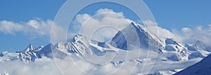 Swiss alps covered in clouds photo