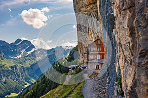 Swiss Alps and a restaurant under a cliff on mountain Ebenalp in Switzerland