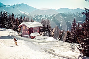 Swiss Chalet and snowboarder in Verbier photo