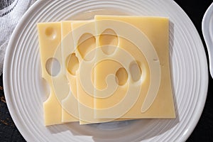Swiss cheese collection, yellow emmentaler or emmental cheese with round holes