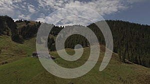 Swiss farm in the alpine mountains of the canton of Obwald seen from a drone