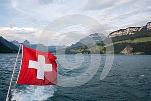 Swiss flag flutter above the lake