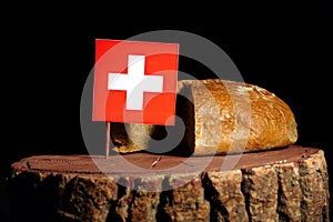 Swiss flag on a stump with bread