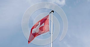 Swiss flag, white cross on red background in real time. Switzerland, texture.