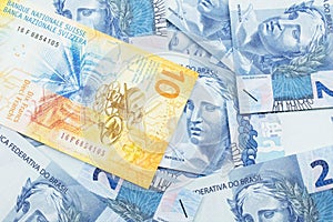 A Swiss franc bank note with Brazilian two reais bank notes