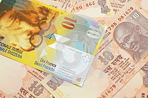 A Swiss franc bank note with Indian ten rupee bank notes