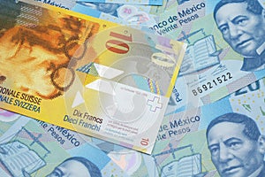 A Swiss franc bank note with Mexican twenty peso bank notes