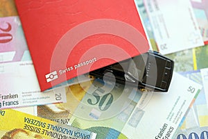 Swiss franc banknotes and toy car with passport. The current francs money bills and car with pass photo