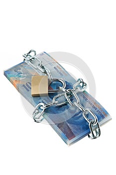 Swiss francs with a lock and chain.