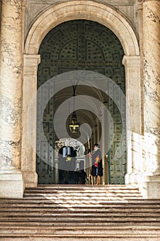 Swiss guard in front of the entrance at Saint Peter`s Basilica.