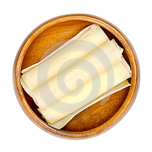 Swiss hard cheese rolls, rolled thin slices of Sbrinz, in wooden bowl