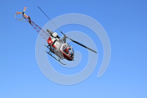 Swiss helicopter is flying in the Bernese Oberland