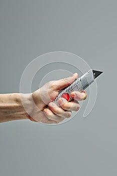 Swiss knife for cutting in hands of unrecognizable man