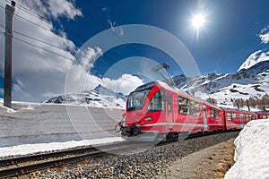 Swiss mountain train Bernina Express crossed Alps with snow wall photo