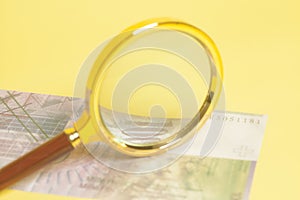 Swiss one thousand 1000 Franc banknotes under magnifying glass