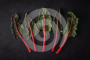 Swiss Rainbow chard, silverbeet or mangold over rustic blue textured background