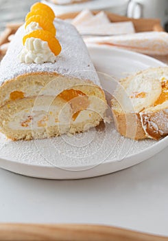 Swiss roll cake with mandarin orange filling on a platter