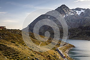 Swiss train in the alps and lake around Bernina pass, Engadine, Switzerland