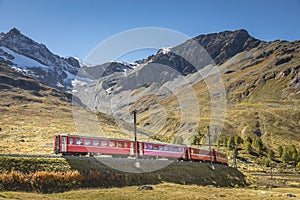 Swiss train in the alps mountains around Bernina pass, Engadine, Switzerland