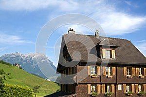 Swiss wooden House in Alps Mountain landscape