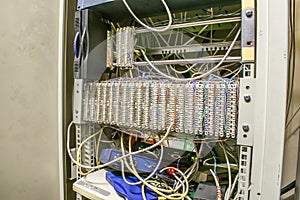 A switch box with equipment for telephony and the Internet. Distribution cabinet with patch panels