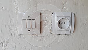Switch and Electric socket and white wall Switch and Electric socket and white wall.