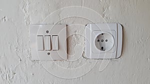 Switch and Electric socket and white wall Switch and Electric socket and white wall.