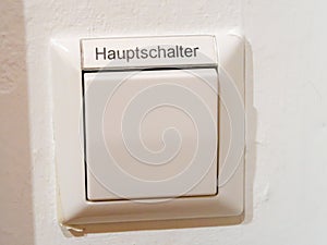 A switch with the german inscription for main switch