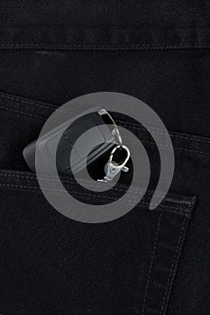 Switch key is lying in side pocket of black pants.