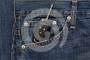 Switch key is lying in side pocket of blue jeans