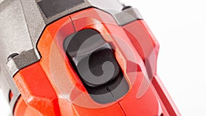 Switch in a modern screwdriver on a drill, close-up. White background, isolate, industry