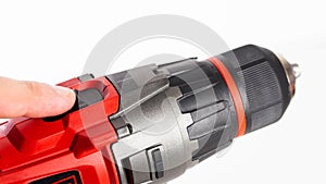 Switch in a modern screwdriver on a drill, close-up. White background, isolate, industry