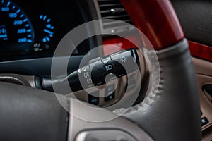 Switch off lights in a car. close-up Car integrated turning indicator with headlight switch toggle.