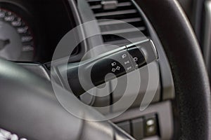 Switch off lights in a car. close-up Car integrated turning indicator with headlight switch toggle.