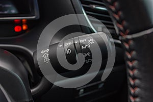 Switch off lights in a car. close-up Car integrated turning indicator with headlight switch toggle.