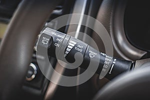 Switch off lights in a car. close-up Car integrated turning indicator with headlight switch toggle.