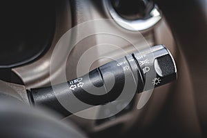 Switch off lights in a car. close-up Car integrated turning indicator with headlight switch toggle.