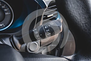 Switch off lights in a car. close-up Car integrated turning indicator with headlight switch toggle.