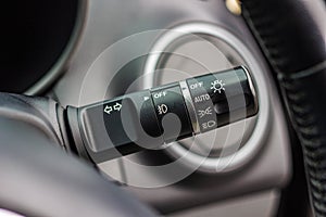 Switch off lights in a car. close-up Car integrated turning indicator with headlight switch toggle.