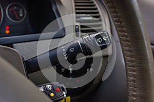 Switch off lights in a car. close-up Car integrated turning indicator with headlight switch toggle.