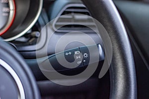 Switch off lights in a car. close-up Car integrated turning indicator with headlight switch toggle.