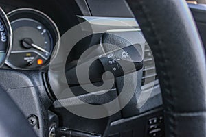 Switch off lights in a car. close-up Car integrated turning indicator with headlight switch toggle.