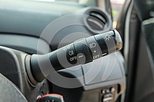 Switch off lights in a car. close-up Car integrated turning indicator with headlight switch toggle.