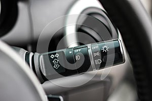 Switch off lights in a car. close-up Car integrated turning indicator with headlight switch toggle.