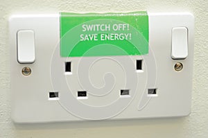 Save energy sign on plug sockets photo