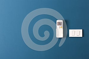 Switch off - turn and air remote control on the blue wall