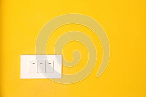 Switch on yellow wall