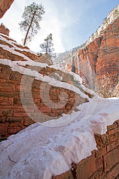 Switchbacks in snow on Angels Landing Hiking Trail during winter in Zion National Park in Utah