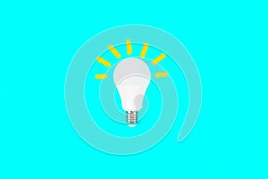 Switched on light bulb on a light blue background - a symbol of a new idea, innovation