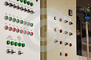 Switches on an industrial control board. Lamp indicator and switch of power control panel